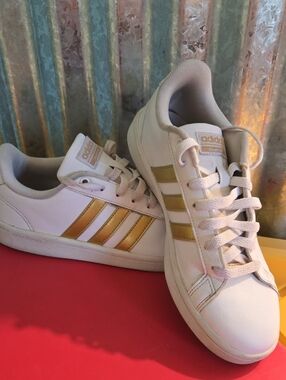 adidas White Sneakers with Gold Stripe Details